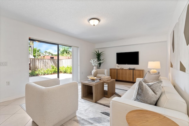 744 Buttonwood Ln Unit 411-D, Boynton Beach, FL 33436 - living room featuring a textured ceiling and baseboards