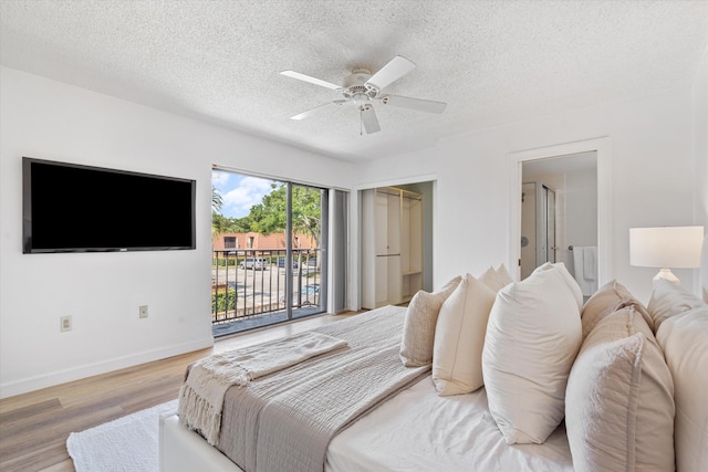 744 Buttonwood Ln Unit 411-D, Boynton Beach, FL 33436 - bedroom with access to exterior, a textured ceiling, light wood-style flooring, a ceiling fan, and baseboards