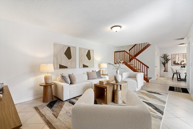 744 Buttonwood Ln Unit 411-D, Boynton Beach, FL 33436 - living area featuring light tile patterned flooring, stairway, a textured ceiling, and baseboards