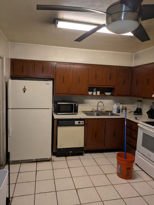 3900 Kenas St, West Palm Beach, FL 33403 - kitchen with white appliances, a sink, light countertops, and a ceiling fan