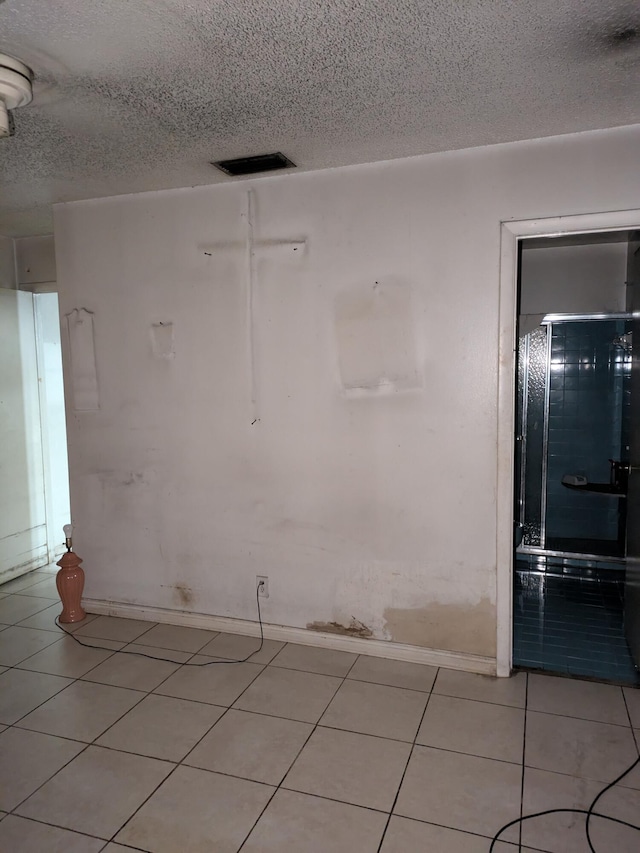 3900 Kenas St, West Palm Beach, FL 33403 - spare room featuring a textured ceiling and baseboards
