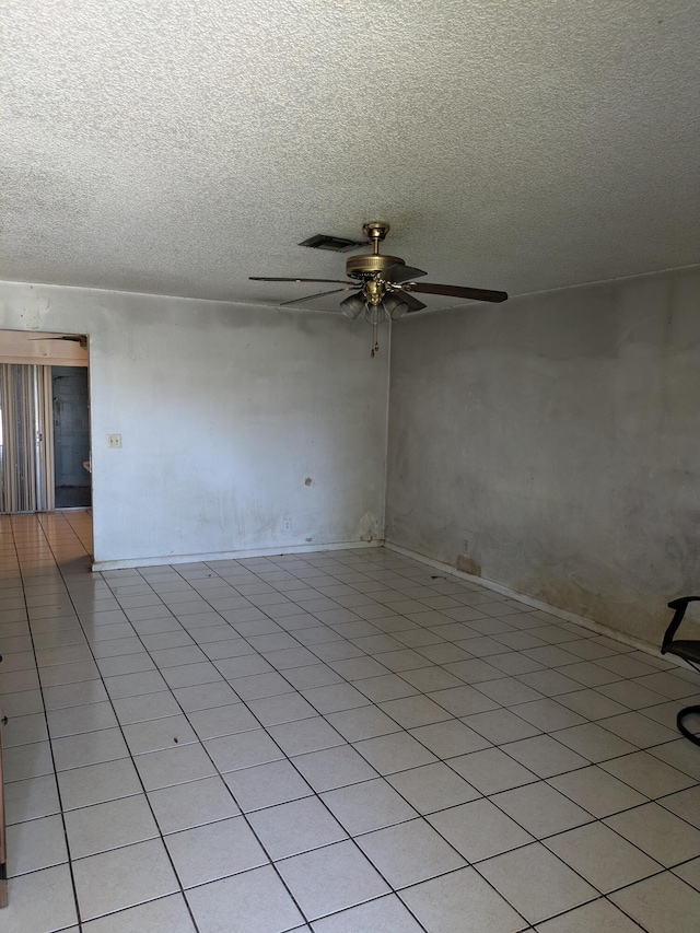 3900 Kenas St, West Palm Beach, FL 33403 - unfurnished room with ceiling fan, a textured ceiling, and light tile patterned floors