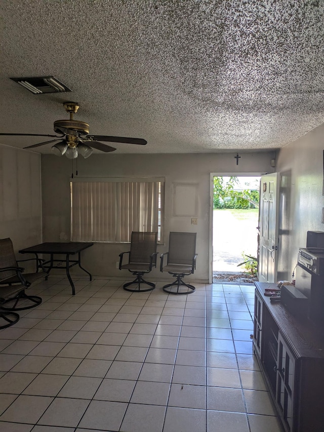 3900 Kenas St, West Palm Beach, FL 33403 - living area with a textured ceiling, light tile patterned floors, and ceiling fan