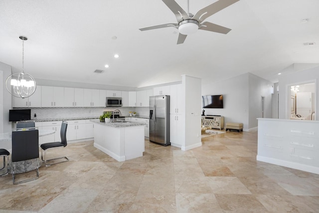 7216 Copperfield Cir, Lake Worth, FL 33467 - kitchen featuring stainless steel appliances, lofted ceiling, a ceiling fan, white cabinets, and a center island