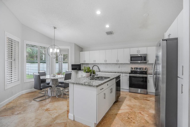 7216 Copperfield Cir, Lake Worth, FL 33467 - kitchen featuring appliances with stainless steel finishes, a sink, white cabinetry, decorative backsplash, and a textured ceiling