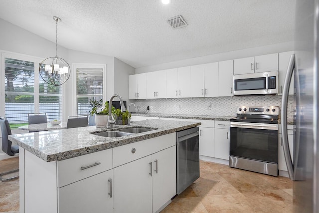 7216 Copperfield Cir, Lake Worth, FL 33467 - kitchen featuring appliances with stainless steel finishes, a sink, a chandelier, tasteful backsplash, and vaulted ceiling