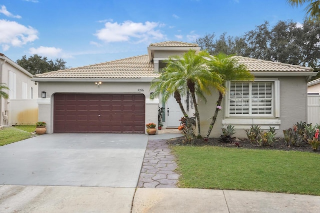7216 Copperfield Cir, Lake Worth, FL 33467 - mediterranean / spanish house featuring an attached garage, concrete driveway, stucco siding, a tiled roof, and a front yard