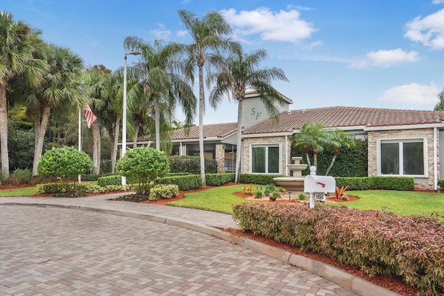 7216 Copperfield Cir, Lake Worth, FL 33467 - rear view of property with a tile roof, stone siding, and a lawn