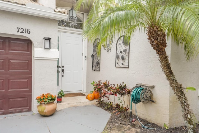 7216 Copperfield Cir, Lake Worth, FL 33467 - entrance to property with stucco siding and an attached garage