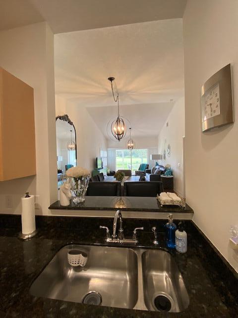 4240 Gator Trace Ave Unit 0, Fort Pierce, FL 34982 - kitchen featuring a sink, dark stone countertops, and hanging light fixtures