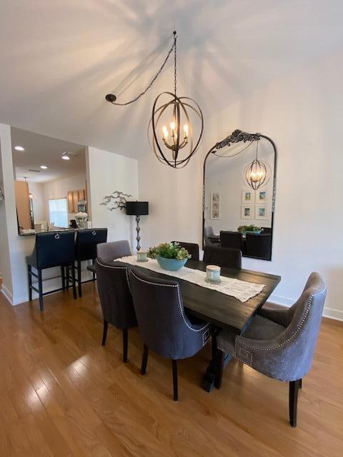 4240 Gator Trace Ave Unit 0, Fort Pierce, FL 34982 - dining space featuring a chandelier, wood finished floors, and baseboards