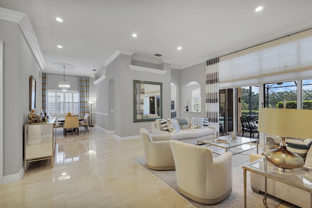 101 Sedona Way, Palm Beach Gardens, FL 33418 - living area with crown molding, baseboards, plenty of natural light, arched walkways, and recessed lighting