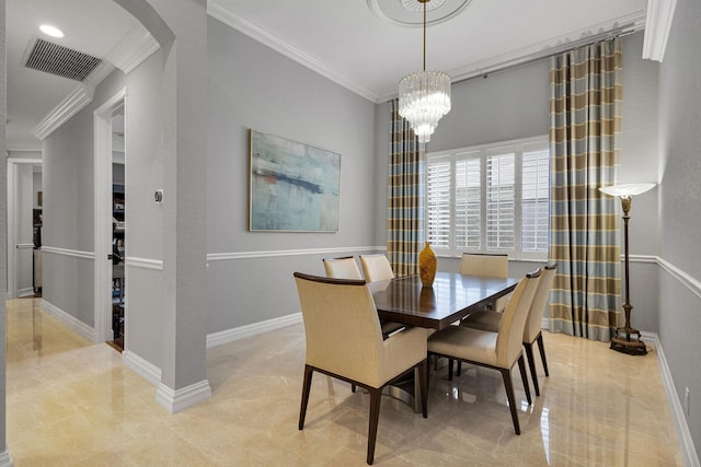 101 Sedona Way, Palm Beach Gardens, FL 33418 - dining space with crown molding, arched walkways, a chandelier, and baseboards