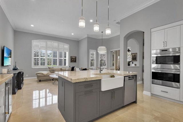 101 Sedona Way, Palm Beach Gardens, FL 33418 - kitchen featuring a sink, appliances with stainless steel finishes, crown molding, gray cabinets, and baseboards