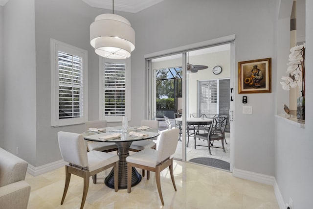101 Sedona Way, Palm Beach Gardens, FL 33418 - dining area featuring baseboards, a high ceiling, and crown molding