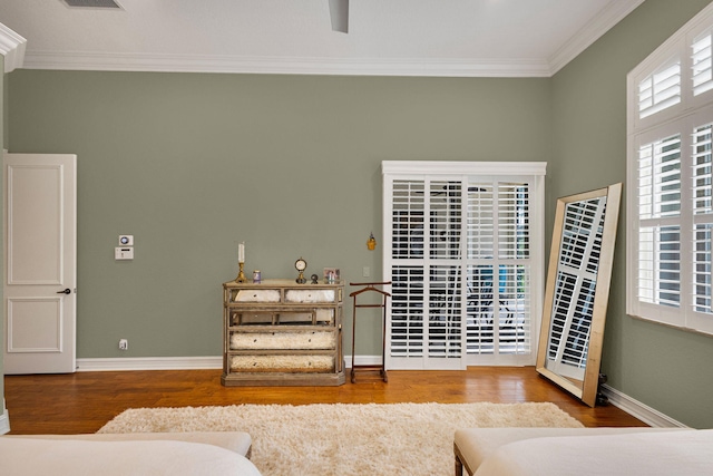 101 Sedona Way, Palm Beach Gardens, FL 33418 - bedroom featuring crown molding, wood finished floors, multiple windows, and baseboards