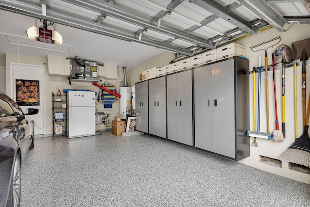 101 Sedona Way, Palm Beach Gardens, FL 33418 - garage featuring freestanding refrigerator, a garage door opener, and gas water heater