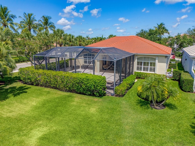 101 Sedona Way, Palm Beach Gardens, FL 33418 - rear view of property with a tile roof, a patio, a lawn, and a lanai