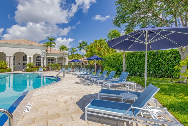 101 Sedona Way, Palm Beach Gardens, FL 33418 - community pool featuring a patio and a lawn