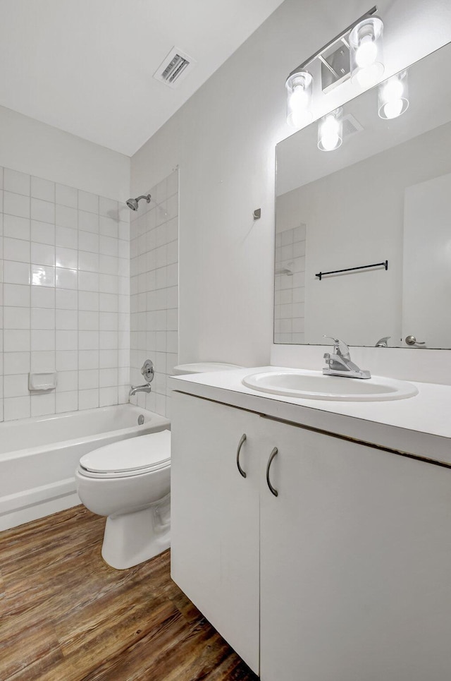 5171 Glencove Ln, West Palm Beach, FL 33415 - full bathroom with vanity, toilet, washtub / shower combination, and wood finished floors
