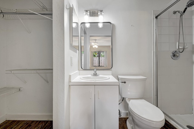 5171 Glencove Ln, West Palm Beach, FL 33415 - bathroom featuring a walk in closet, toilet, vanity, and a stall shower