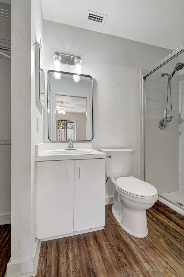 5171 Glencove Ln, West Palm Beach, FL 33415 - full bath featuring toilet, a shower stall, wood finished floors, vanity, and ceiling fan