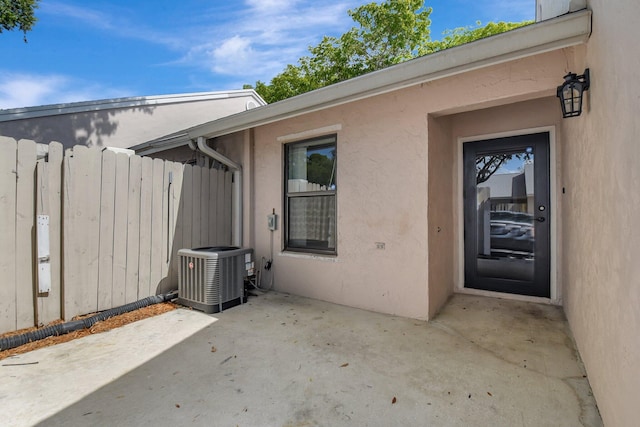 5171 Glencove Ln, West Palm Beach, FL 33415 - doorway to property with central air condition unit, a patio, and stucco siding