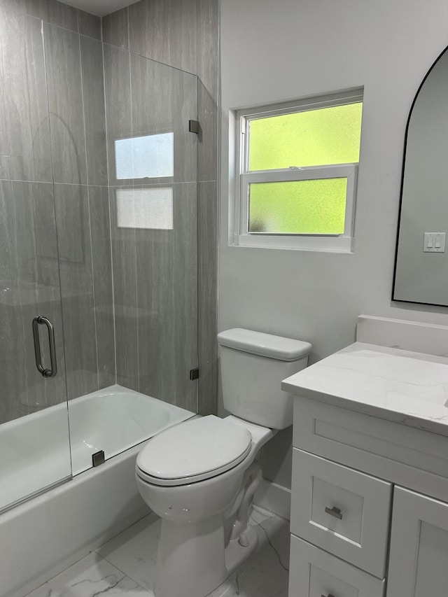 18228 48th Ave N, The Acreage, FL 33470 - bathroom with marble look tile flooring, vanity, toilet, and shower / bath combination with glass door