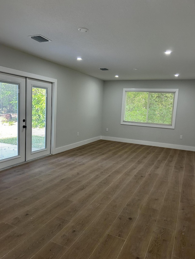18228 48th Ave N, The Acreage, FL 33470 - spare room featuring plenty of natural light, dark wood-style flooring, recessed lighting, baseboards, and french doors