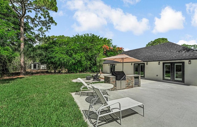 18228 48th Ave N, The Acreage, FL 33470 - view of grassy yard featuring french doors and a patio area