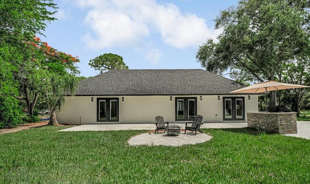 18228 48th Ave N, The Acreage, FL 33470 - back of house with french doors, stucco siding, a yard, and an outdoor fire pit