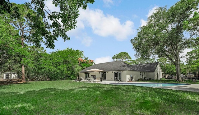 18228 48th Ave N, The Acreage, FL 33470 - rear view of house with a patio, a lawn, and an outdoor pool