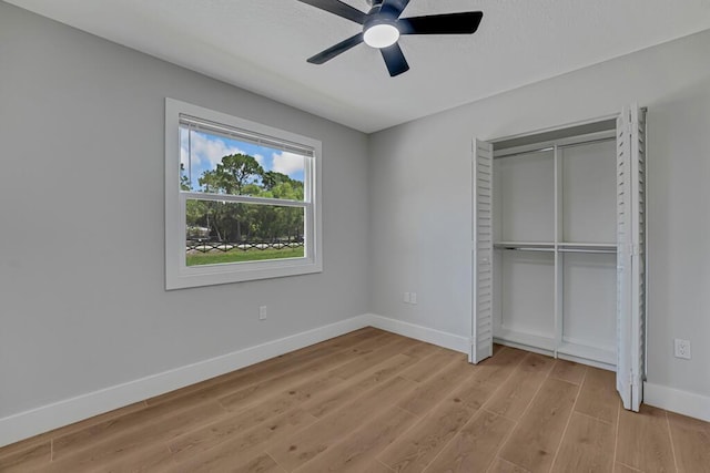 18228 48th Ave N, The Acreage, FL 33470 - unfurnished bedroom with baseboards, light wood-type flooring, a closet, and a ceiling fan