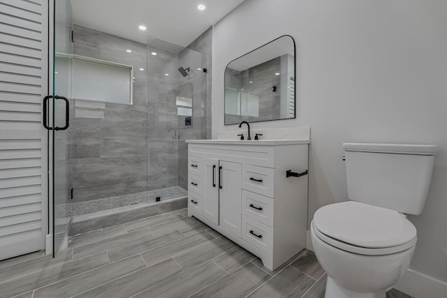 18228 48th Ave N, The Acreage, FL 33470 - bathroom featuring toilet, vanity, a stall shower, and recessed lighting