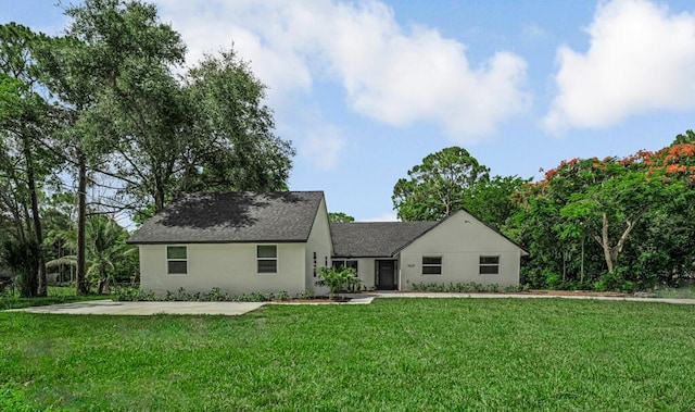 18228 48th Ave N, The Acreage, FL 33470 - view of front of house featuring a front yard, roof with shingles, and stucco siding