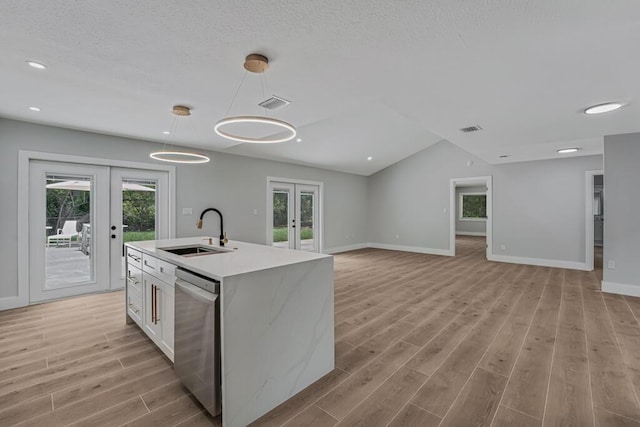 18228 48th Ave N, The Acreage, FL 33470 - kitchen featuring french doors, a sink, dishwasher, light wood-style floors, and plenty of natural light