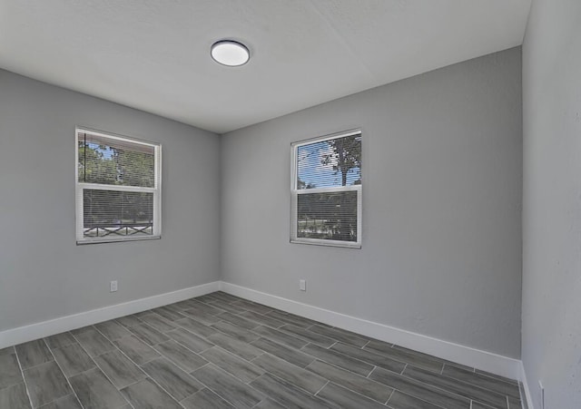 18228 48th Ave N, The Acreage, FL 33470 - unfurnished room featuring plenty of natural light, baseboards, and wood tiled floors