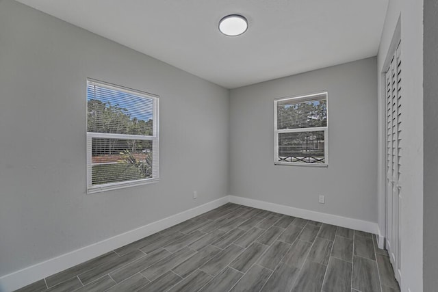 18228 48th Ave N, The Acreage, FL 33470 - unfurnished bedroom featuring baseboards and dark wood finished floors