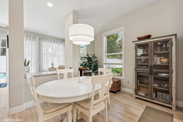 5096 SE Sweetbrier Ter, Hobe Sound, FL 33455 - dining room featuring baseboards and light wood-style flooring