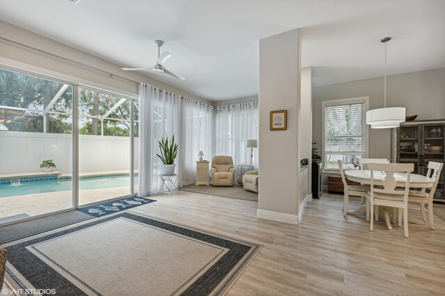 5096 SE Sweetbrier Ter, Hobe Sound, FL 33455 - living room featuring wood finished floors, a ceiling fan, and baseboards