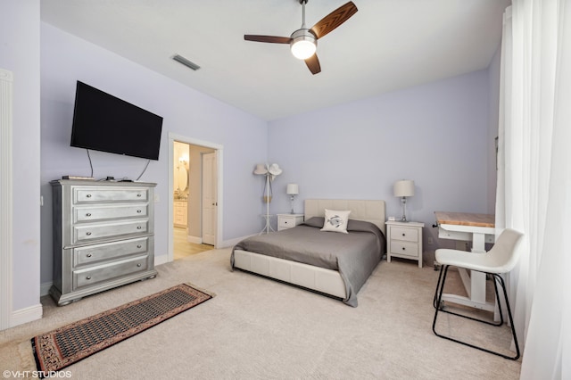 5096 SE Sweetbrier Ter, Hobe Sound, FL 33455 - bedroom with light carpet, baseboards, a ceiling fan, and ensuite bathroom