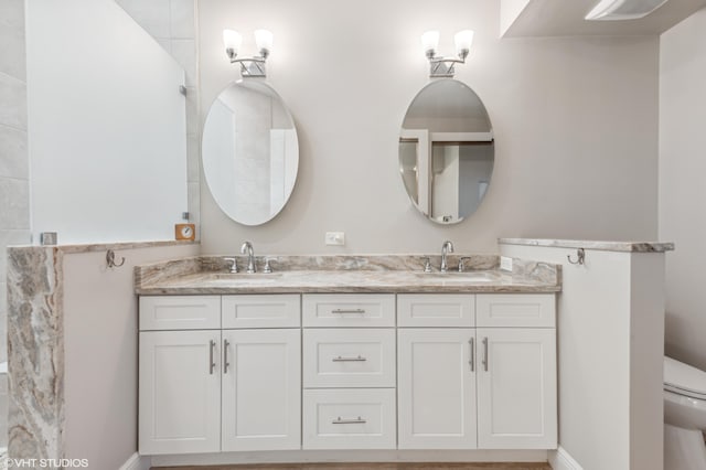 5096 SE Sweetbrier Ter, Hobe Sound, FL 33455 - bathroom featuring double vanity and toilet
