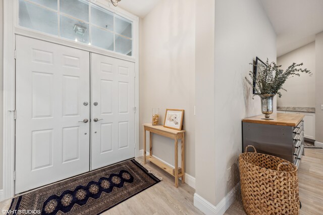 5096 SE Sweetbrier Ter, Hobe Sound, FL 33455 - foyer entrance with light wood-style flooring and baseboards