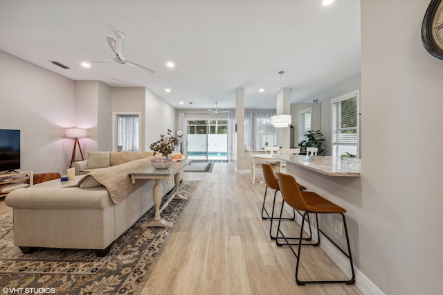 5096 SE Sweetbrier Ter, Hobe Sound, FL 33455 - living room featuring a ceiling fan, light wood finished floors, plenty of natural light, recessed lighting, and baseboards