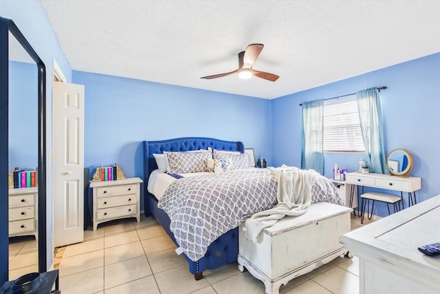 1430 SE Ocean Ln, Port Saint Lucie, FL 34983 - bedroom with light tile patterned floors, a textured ceiling, and a ceiling fan
