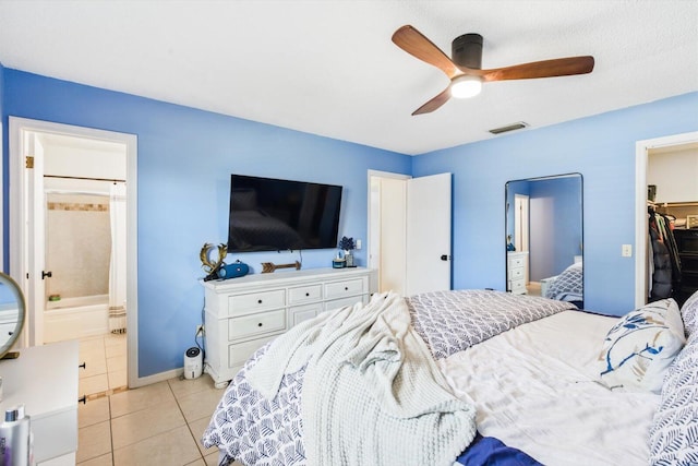 1430 SE Ocean Ln, Port Saint Lucie, FL 34983 - bedroom featuring tile patterned flooring, a spacious closet, a ceiling fan, baseboards, and connected bathroom