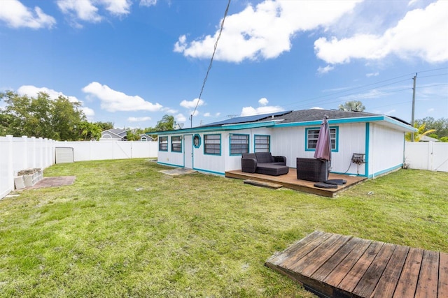 1430 SE Ocean Ln, Port Saint Lucie, FL 34983 - rear view of house featuring a deck, an outdoor living space, solar panels, and a gate