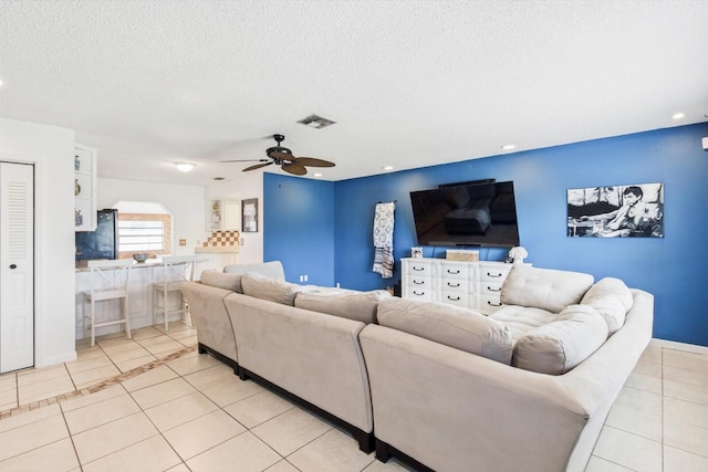 1430 SE Ocean Ln, Port Saint Lucie, FL 34983 - living room featuring light tile patterned flooring, a ceiling fan, and a textured ceiling