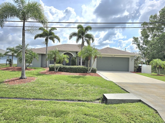 5237 NW Milner Dr, Port Saint Lucie, FL 34983 - single story home with concrete driveway, a garage, stucco siding, and a front lawn