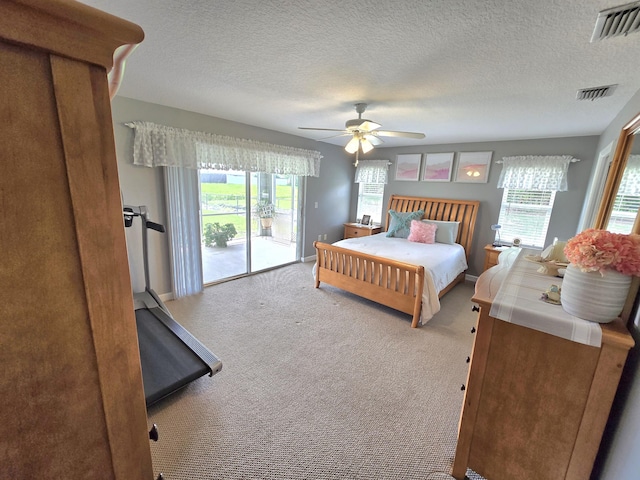 5237 NW Milner Dr, Port Saint Lucie, FL 34983 - carpeted bedroom with access to outside, a textured ceiling, and a ceiling fan